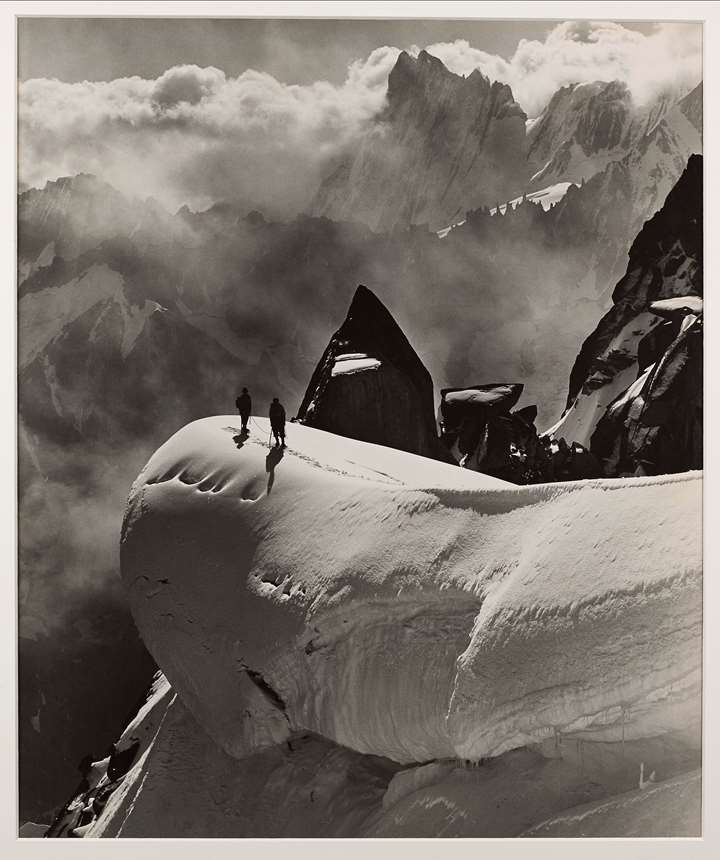 Two climbers traversing the Aiguille du Midi and Aiguille du Plan, Chamonix, France